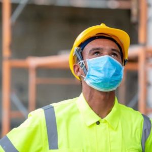 construction site security worker wearing a blue face mask