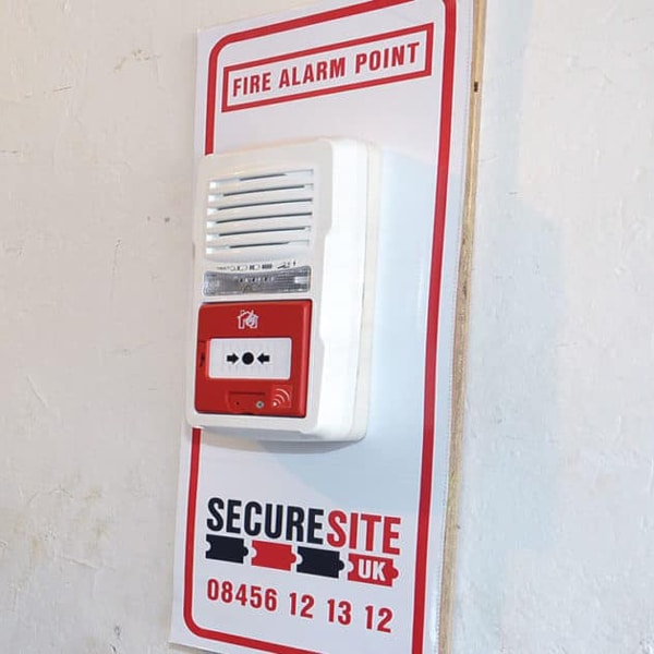 a red and white secure site fire alarm point